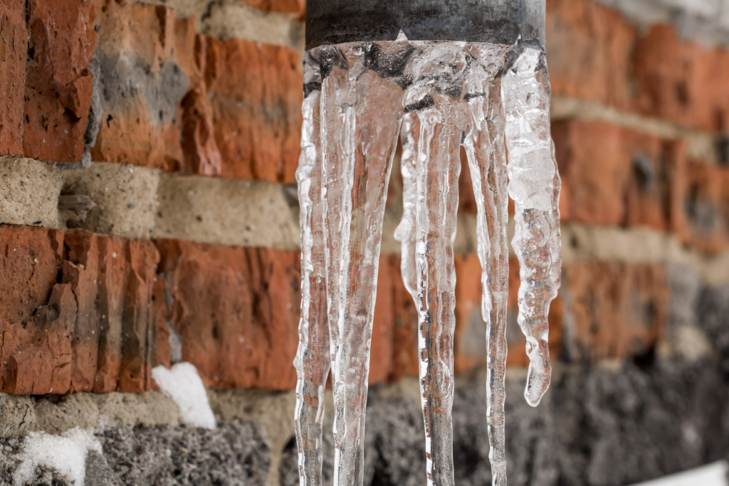 Protecting Your Home from Frozen Pipes in 2025: Essential Tips for Greenville and the Upstate - frozen pipes by a brick wall