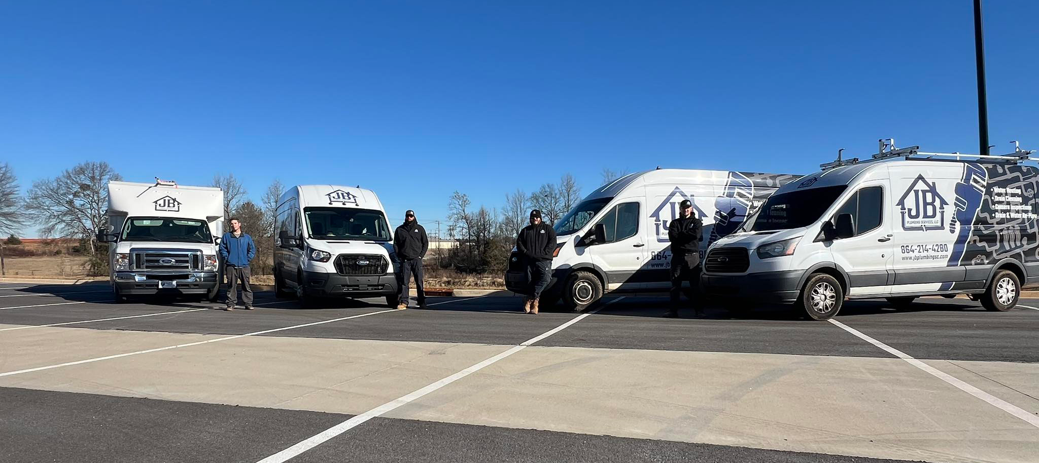 Local Plumbers in Greenville-Spartanburg - Shot of Jean and the team of Plumbing Techs at JB Plumbing Services and their vans