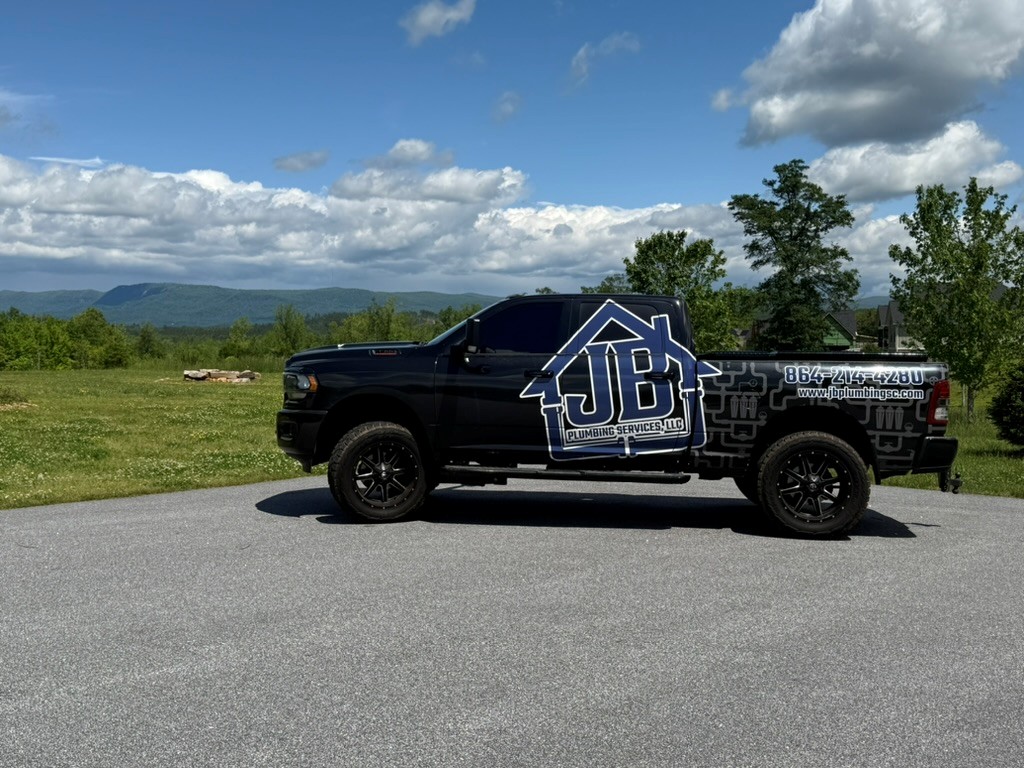Truck wrapped in JB Plumbing branding, your Greenville Plumber, in the Upstate Greer countryside