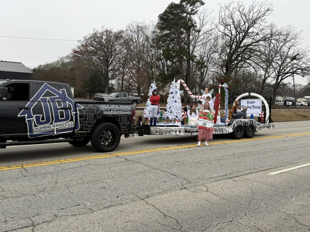 Coming Up 7s: Top Greenville Plumbing Company Reaches 700 5 Star Reviews - Jean's family and their Christmas float